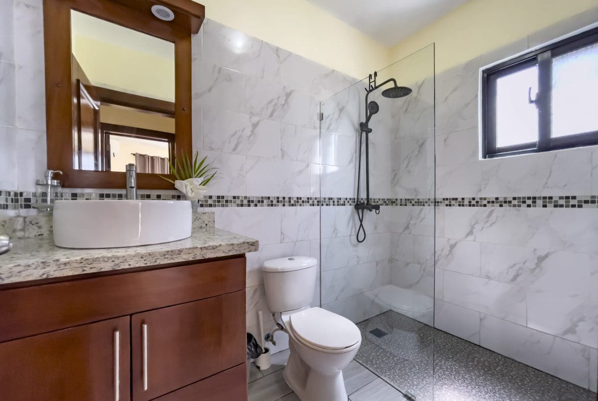 buyDRproperty Modern bathroom with glass shower, white sink, and a 2 Bedroom Villa For Sale Sosua Real Estate