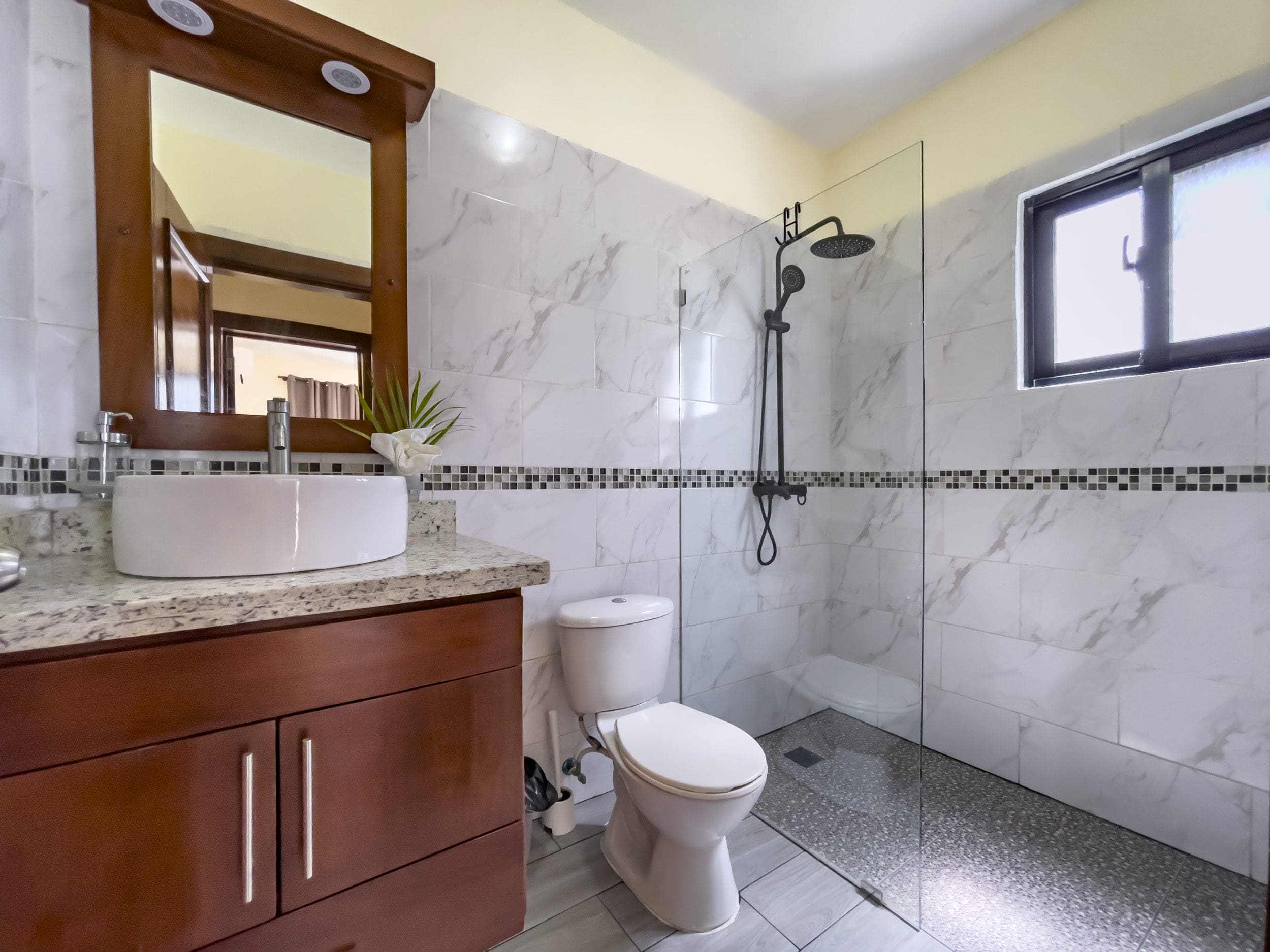 buyDRproperty Modern bathroom with glass shower, white sink, and a 2 Bedroom Villa For Sale Sosua Real Estate