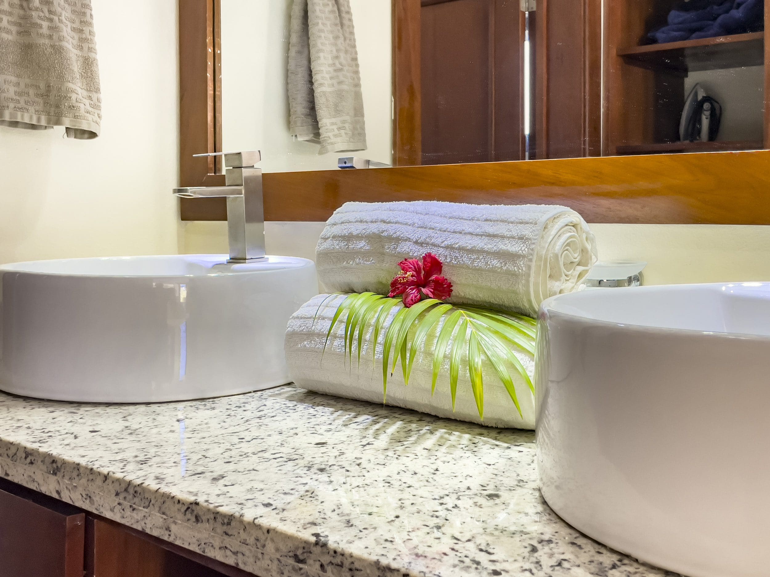 buyDRproperty Bathroom vanity with white sinks, towels, and a red flower. 2 Bedroom Villa For Sale. Sosua Real Estate