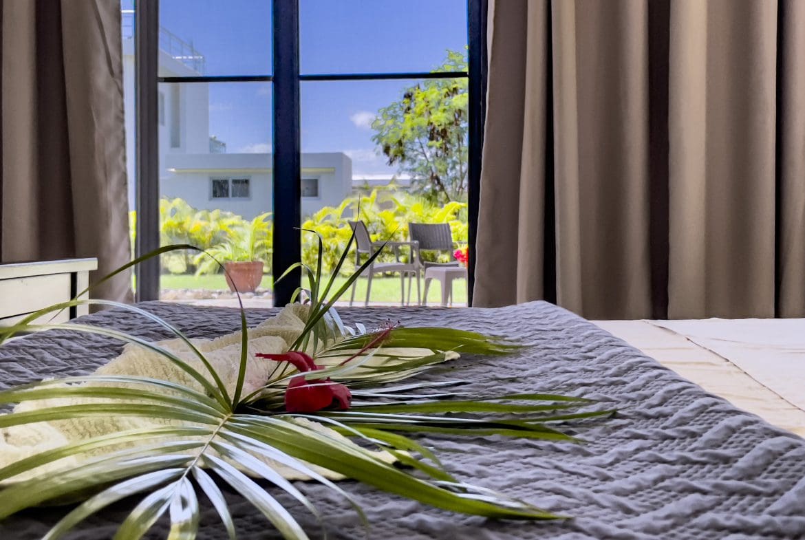 buyDRproperty Bedroom view of a 2 bedroom villa for sale, with tropical decor and outdoor view Sosua Real Estate