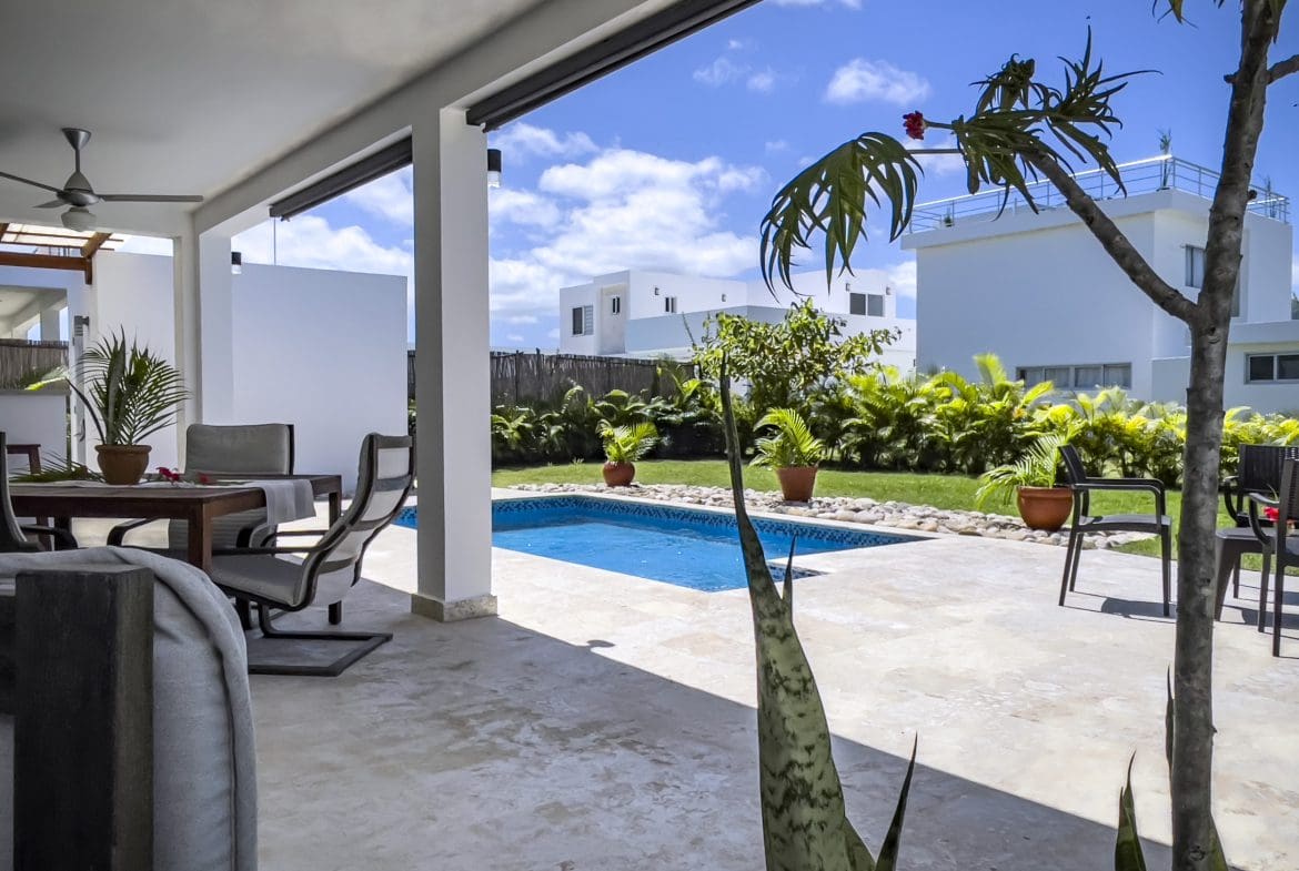buyDRproperty Outdoor area of a 2 bedroom villa for sale with pool and patio furniture. Sosua Real Estate
