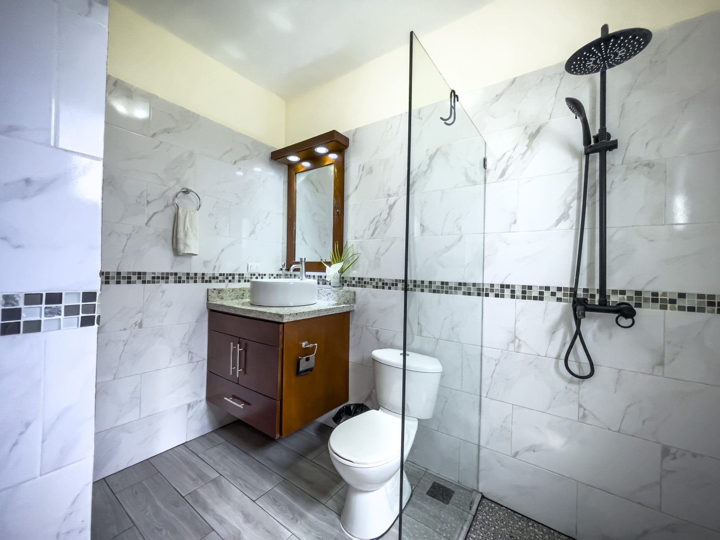 buyDRproperty Modern bathroom with a walk-in shower, toilet, and vanity. 2 Bedroom Villa For Sale. Sosua Real Estate