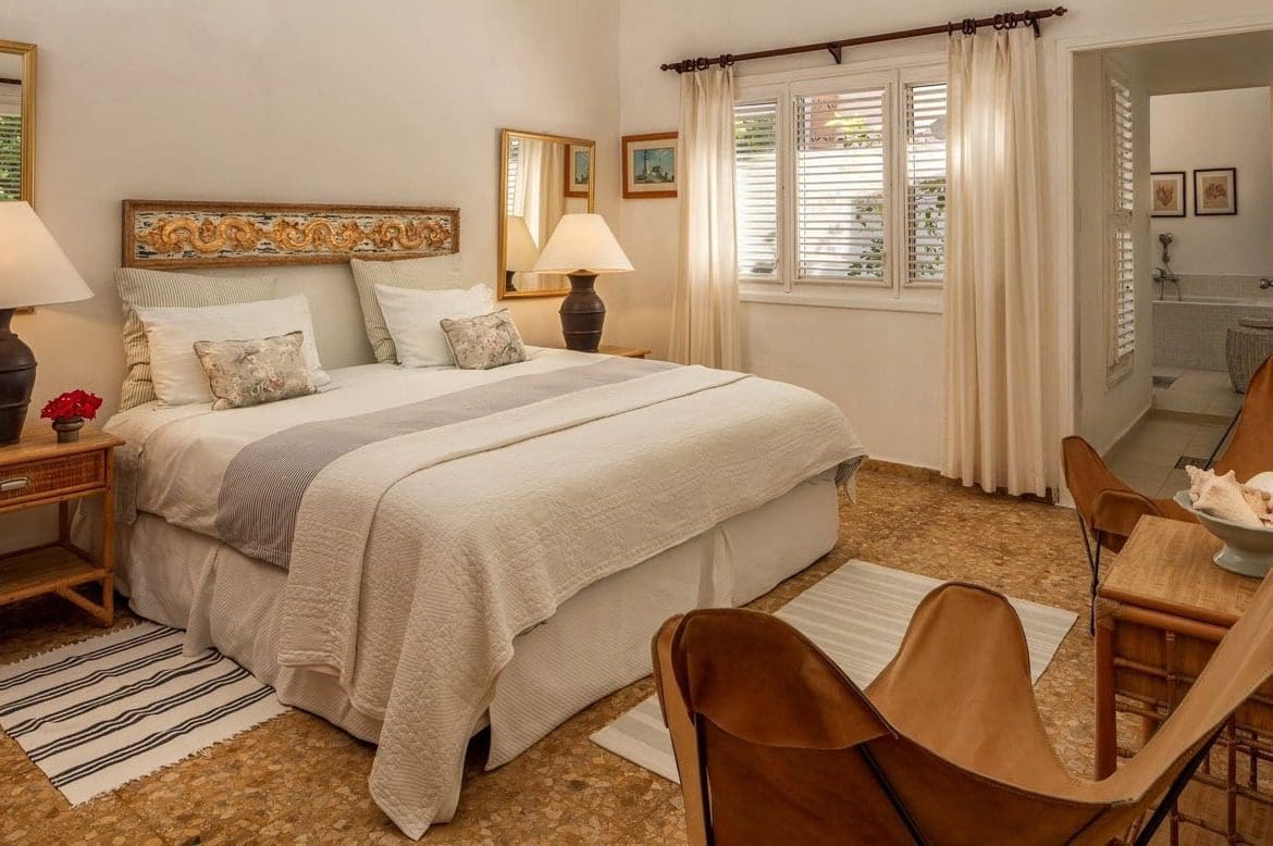 buyDRproperty Bedroom in Villa Blanca with a comfortable bed and seating area. Sosua Real Estate