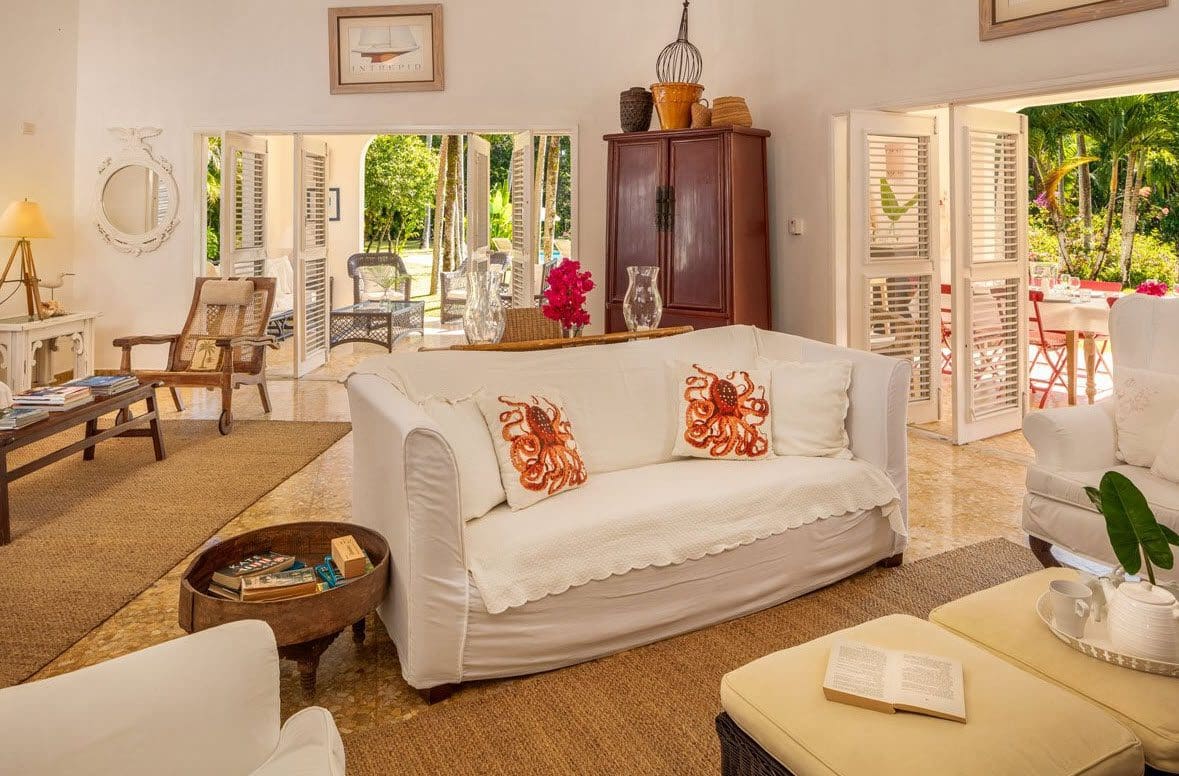 buyDRproperty Living room at Villa Blanca in Sea Horse Ranch. White sofa with octopus pillows, open doors. Sosua Real Estate