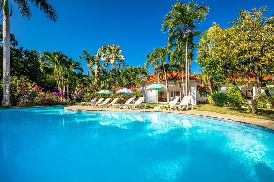 buyDRproperty Villa Blanca luxury pool with lounge chairs and umbrellas, Sea Horse Ranch Sosua Real Estate