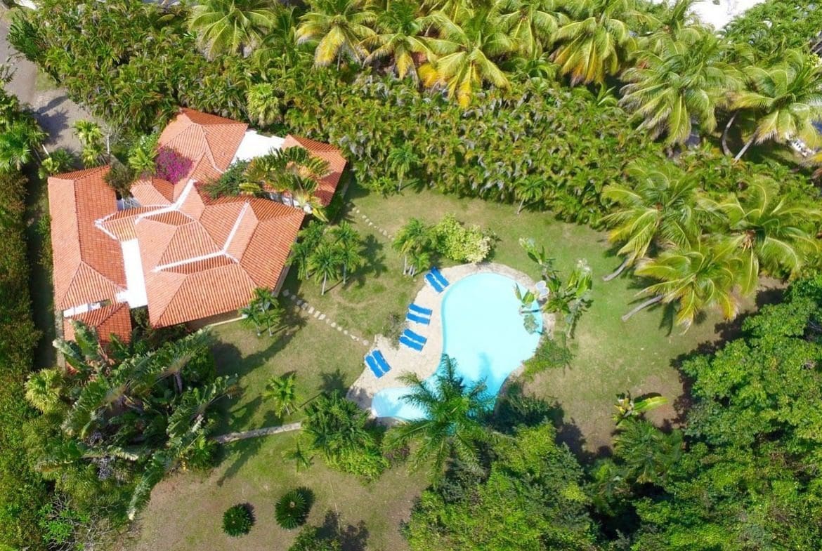 buyDRproperty Aerial view of Villa Blanca, a beautiful estate with a pool and palm trees in Sea Horse Ranch Sosua Real Estate