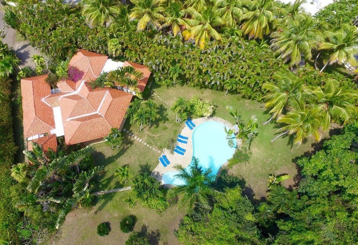 buyDRproperty Aerial view of Villa Blanca, a beautiful estate with a pool and palm trees in Sea Horse Ranch Sosua Real Estate