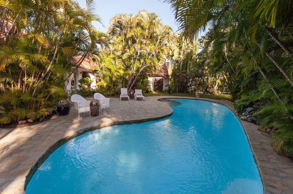 buyDRproperty Sea Horse Ranch Villa pool surrounded by lush tropical landscaping Sosua Real Estate