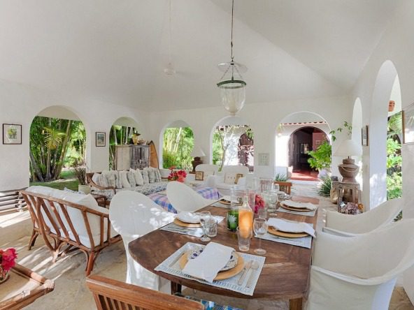 Buydrproperty Sea Horse Ranch Villa Dining Room with Wooden Table and White Chairs Sosua Real Estate Buydrpropertycom Buydrpropertycom