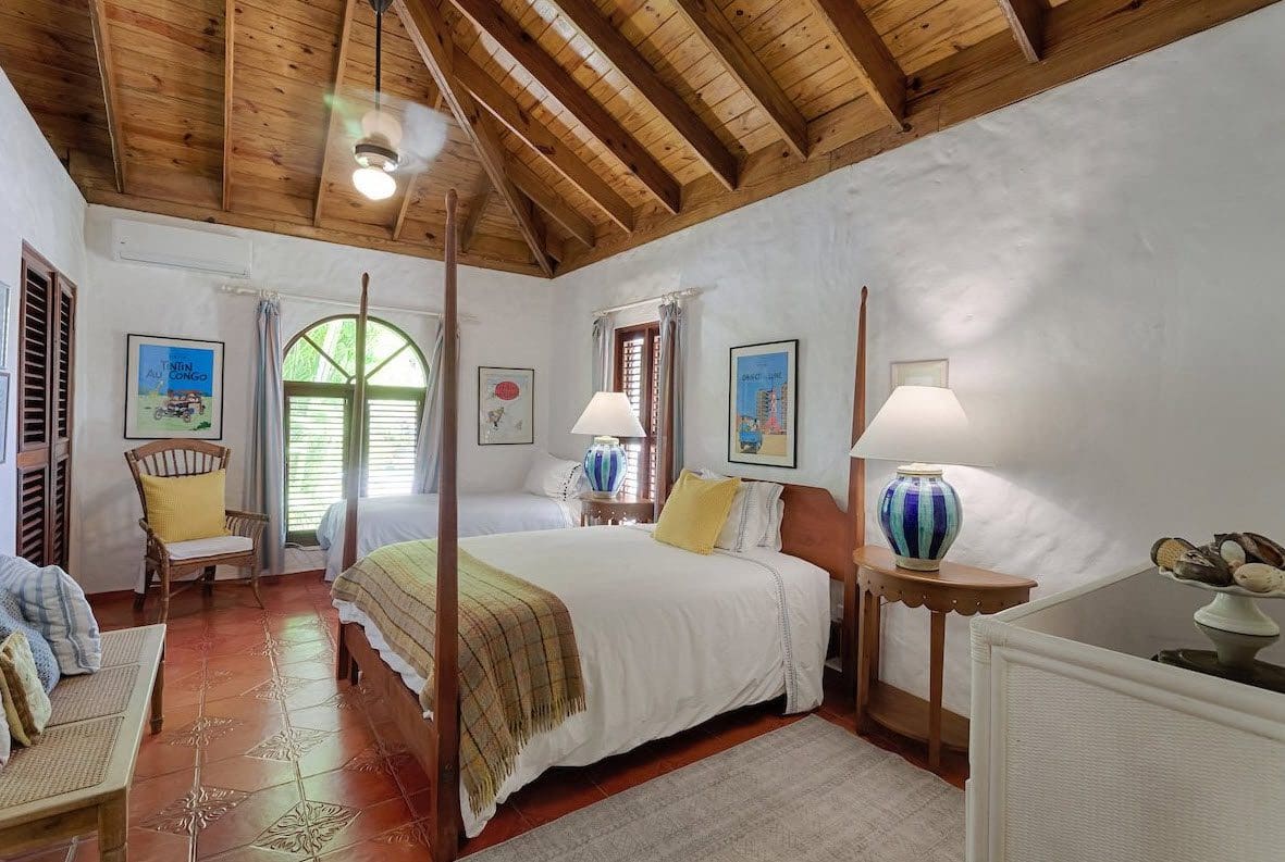 buyDRproperty Bedroom in Sea Horse Ranch Villa with wood ceiling and poster art. Sosua Real Estate