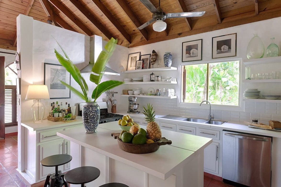 buyDRproperty Bright kitchen in a Sea Horse Ranch Villa with white cabinets and island. Sosua Real Estate