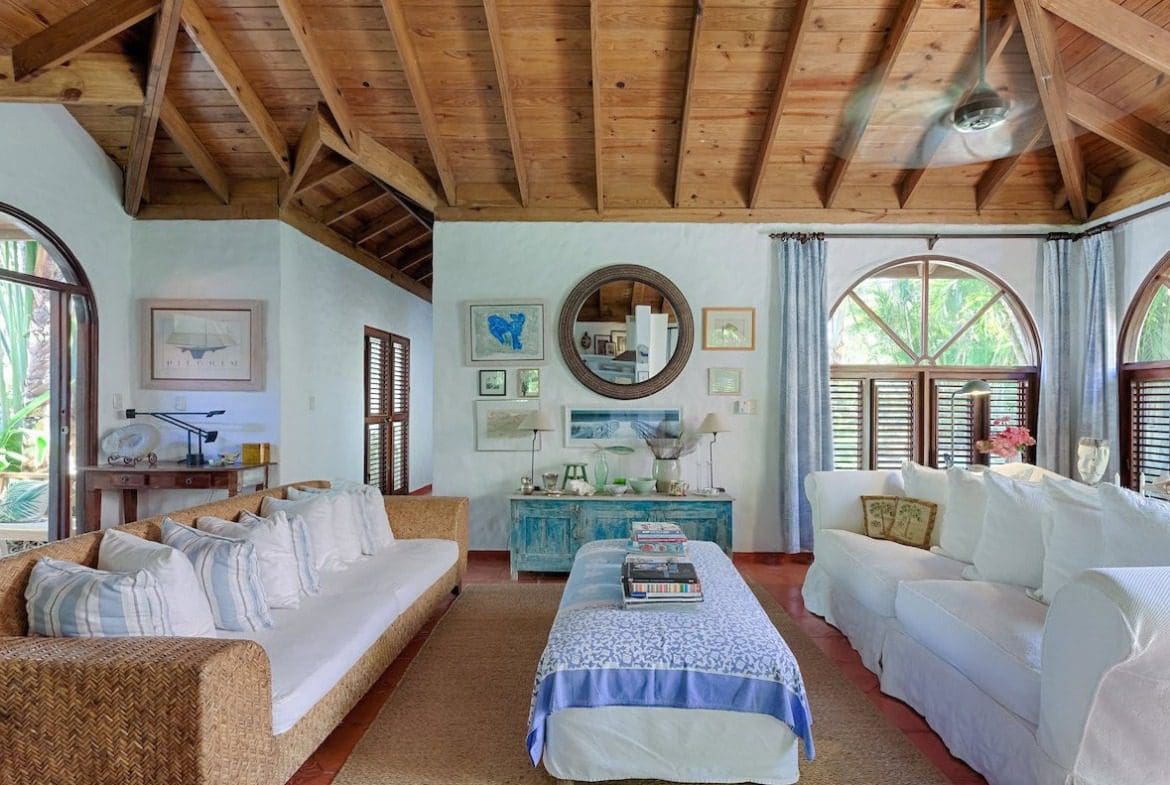 buyDRproperty Coastal living room in a Sea Horse Ranch Villa with white sofas and wood ceiling. Sosua Real Estate