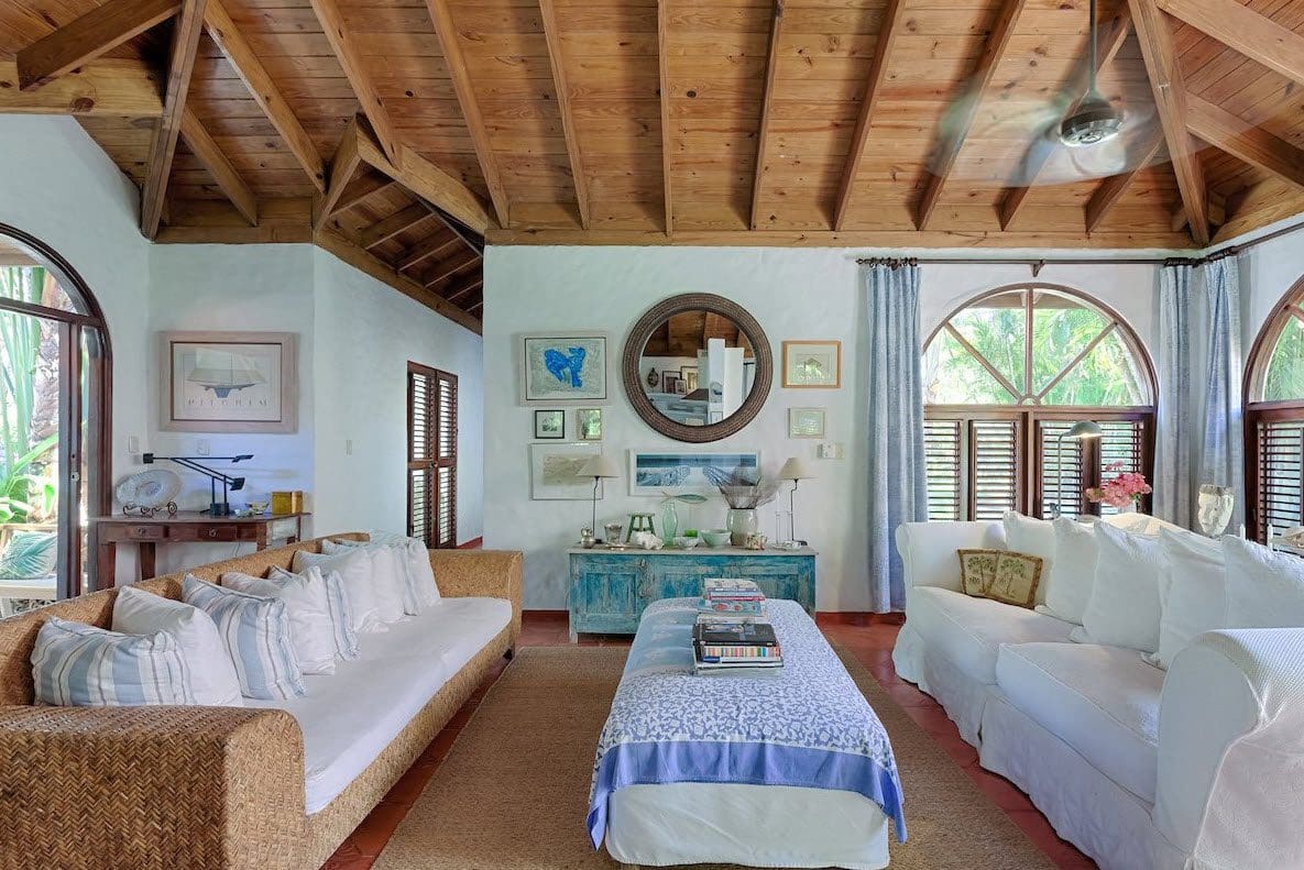 buyDRproperty Coastal living room in a Sea Horse Ranch Villa with white sofas and wood ceiling. Sosua Real Estate