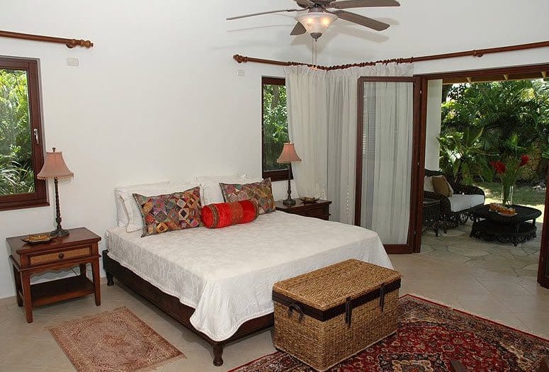 buyDRproperty Bedroom in Beautiful VILLA BRILLANTE with open doors to a patio Sosua Real Estate