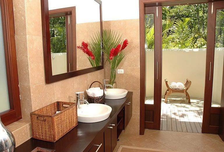 buyDRproperty Beautiful VILLA BRILLANTE bathroom with double sinks and outdoor access. Sosua Real Estate