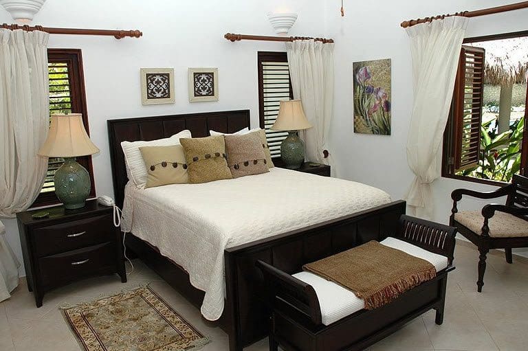 buyDRproperty Bedroom in Beautiful VILLA BRILLANTE with dark wood furniture and a cozy bed. Sosua Real Estate