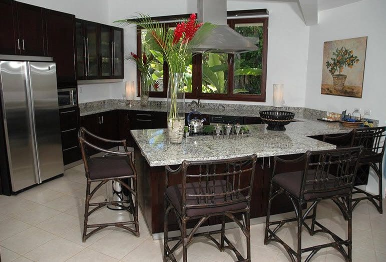 buyDRproperty Beautiful VILLA BRILLANTE kitchen with granite countertops and bar stools. Sosua Real Estate