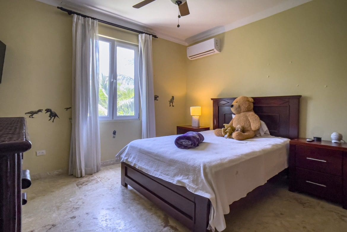 buyDRproperty Bedroom in a Sosua condo for sale with a bed, teddy bear, and window. Sosua Real Estate