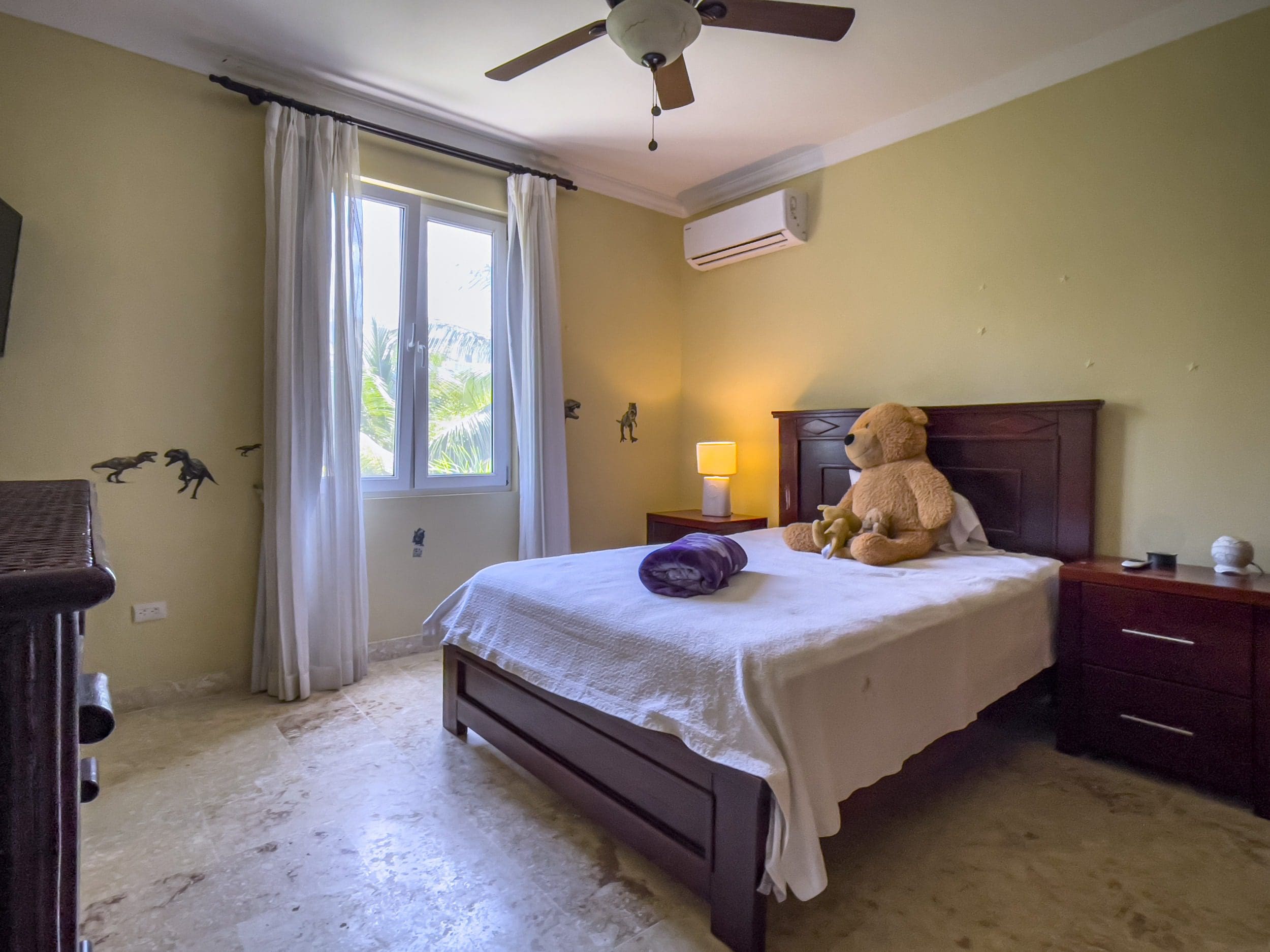 buyDRproperty Bedroom in a Sosua condo for sale with a bed, teddy bear, and window. Sosua Real Estate