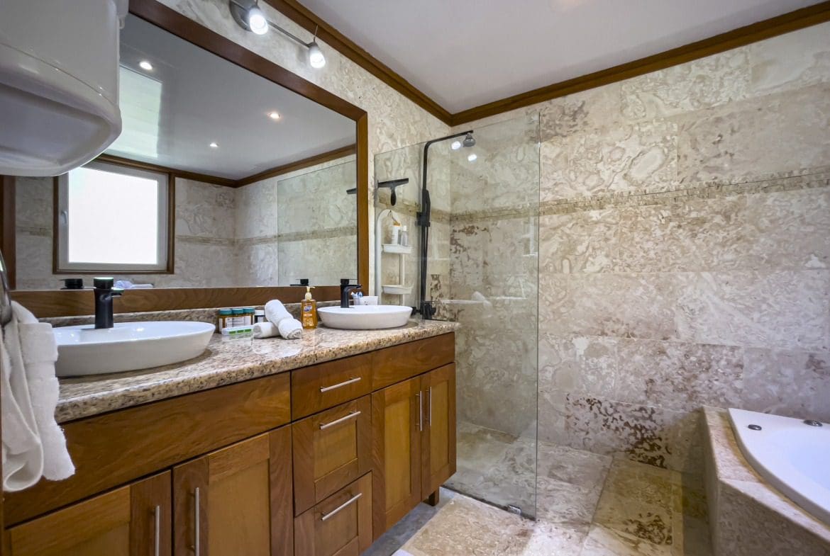buyDRproperty Modern bathroom with double vanity, shower, and tile. Sosua Real Estate