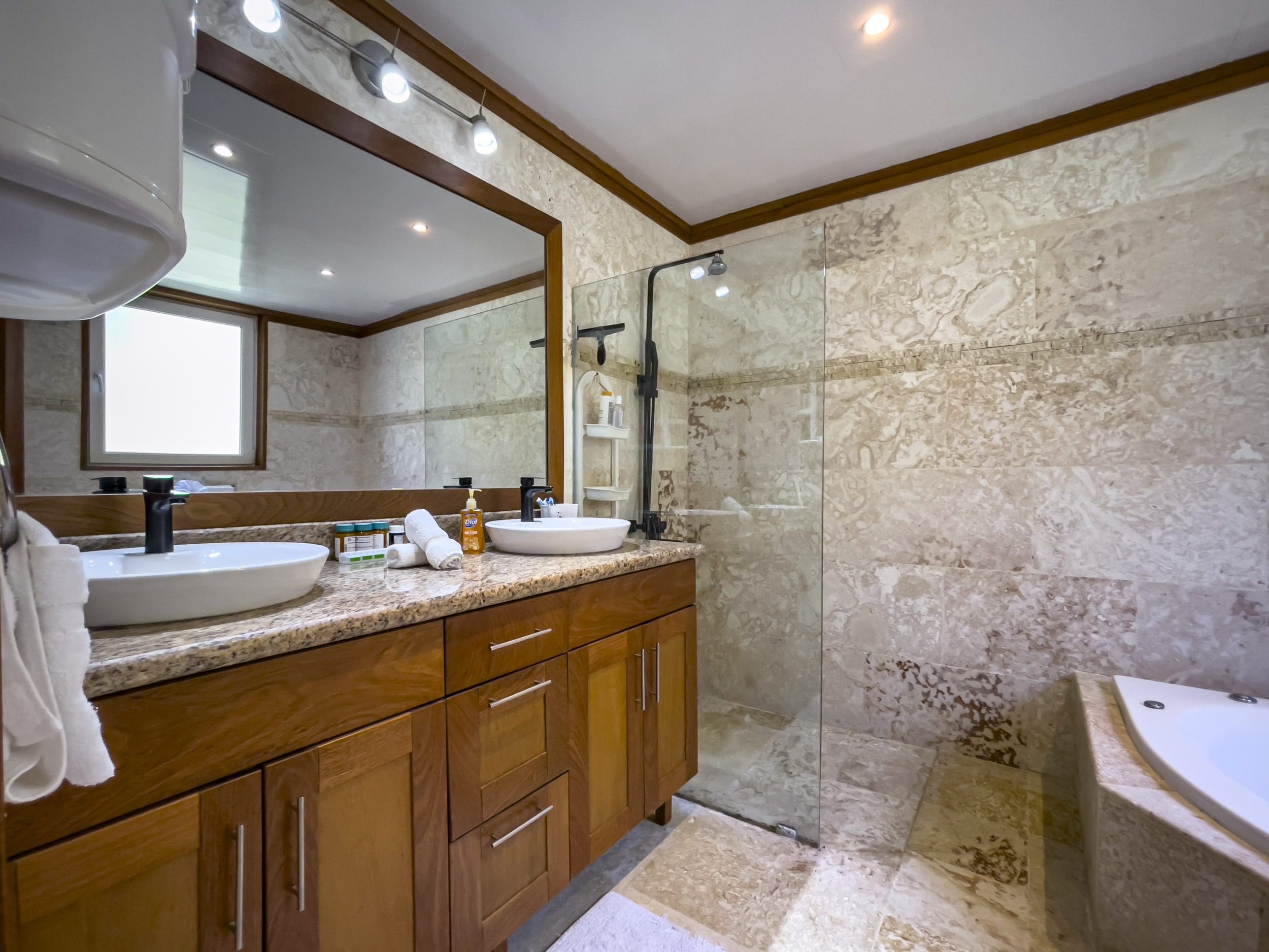buyDRproperty Modern bathroom with double vanity, shower, and tile. Sosua Real Estate