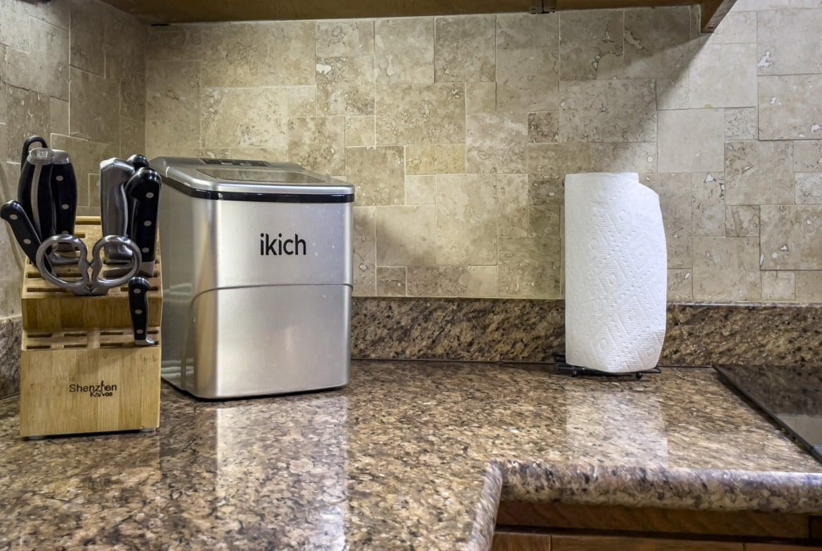 buyDRproperty Kitchen countertop with an ice maker, knife block, and paper towel holder. Sosua Real Estate