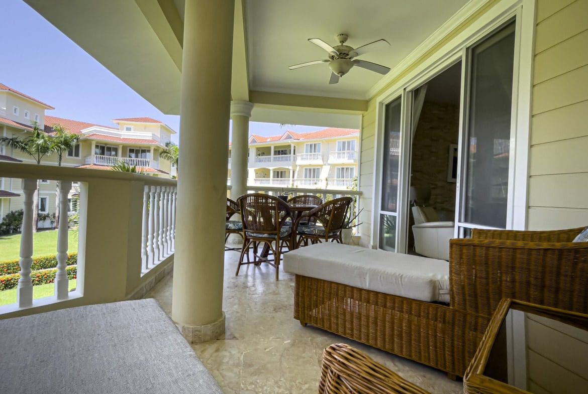 buyDRproperty Oceanfront condo balcony with patio furniture overlooking Sosua Sosua Real Estate