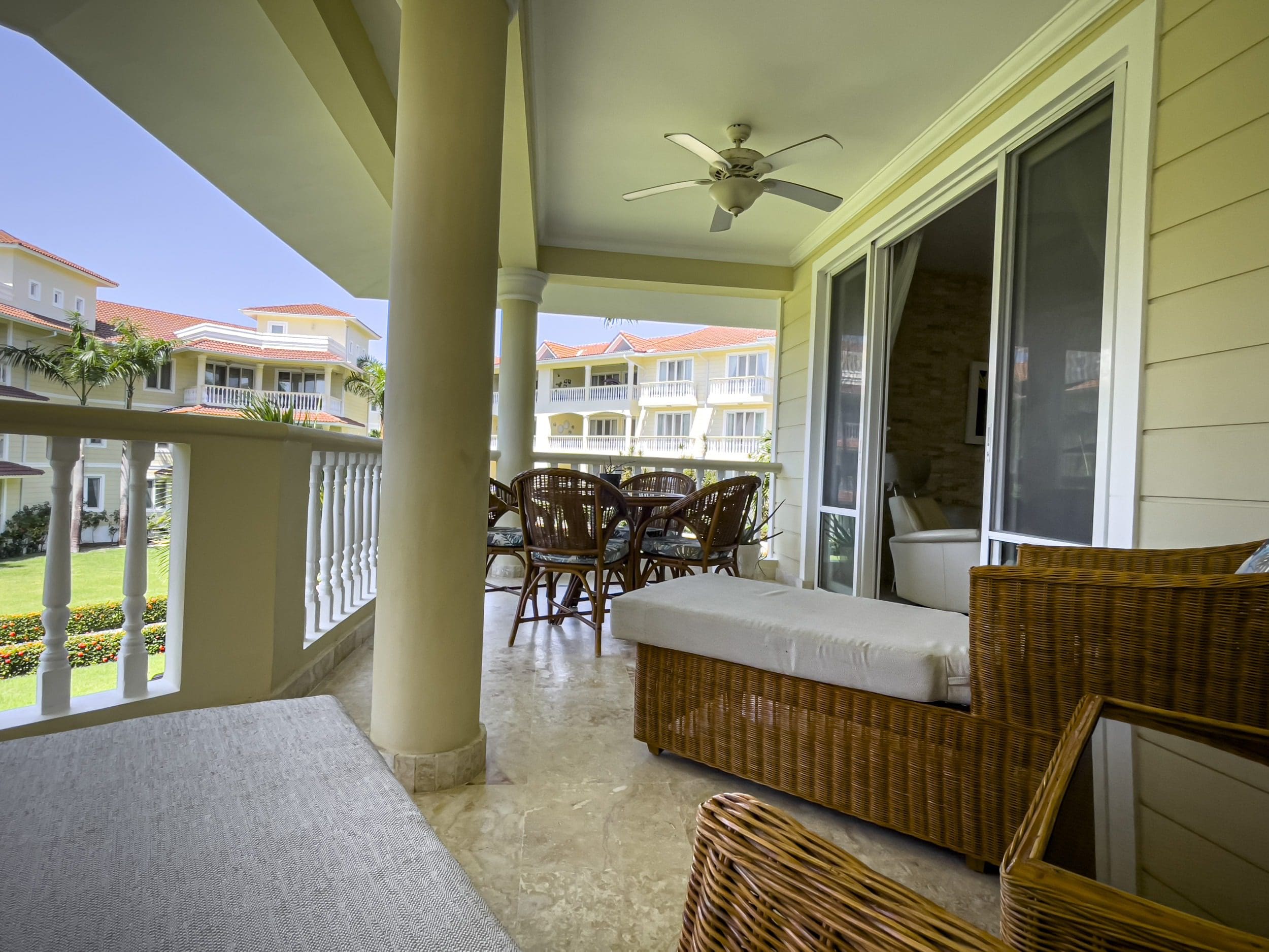 buyDRproperty Oceanfront condo balcony with patio furniture overlooking Sosua Sosua Real Estate