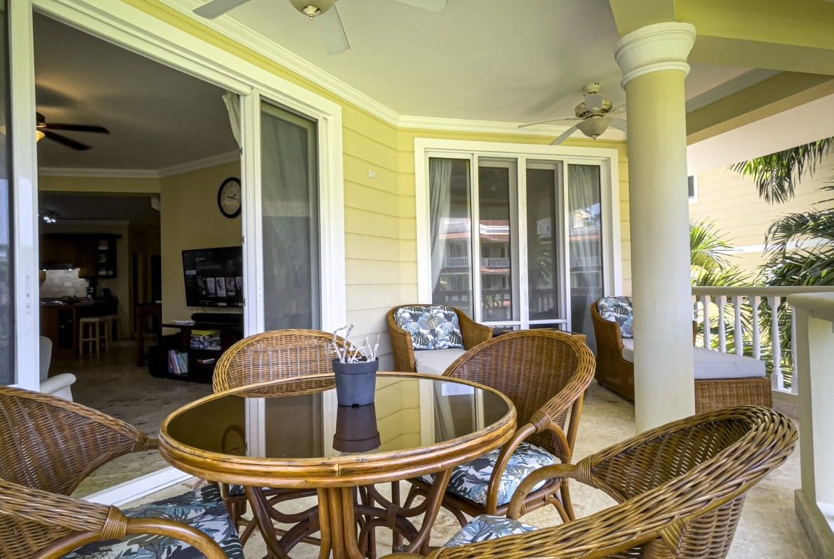 buyDRproperty Wicker patio furniture on a Sosua condo balcony with ocean views Sosua Real Estate