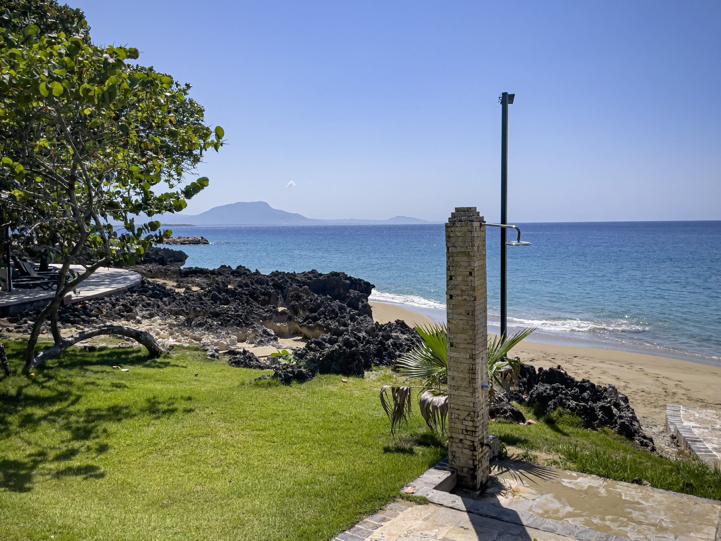 buyDRproperty Oceanfront view from a condo in Sosua with a beach and clear blue water. Sosua Real Estate