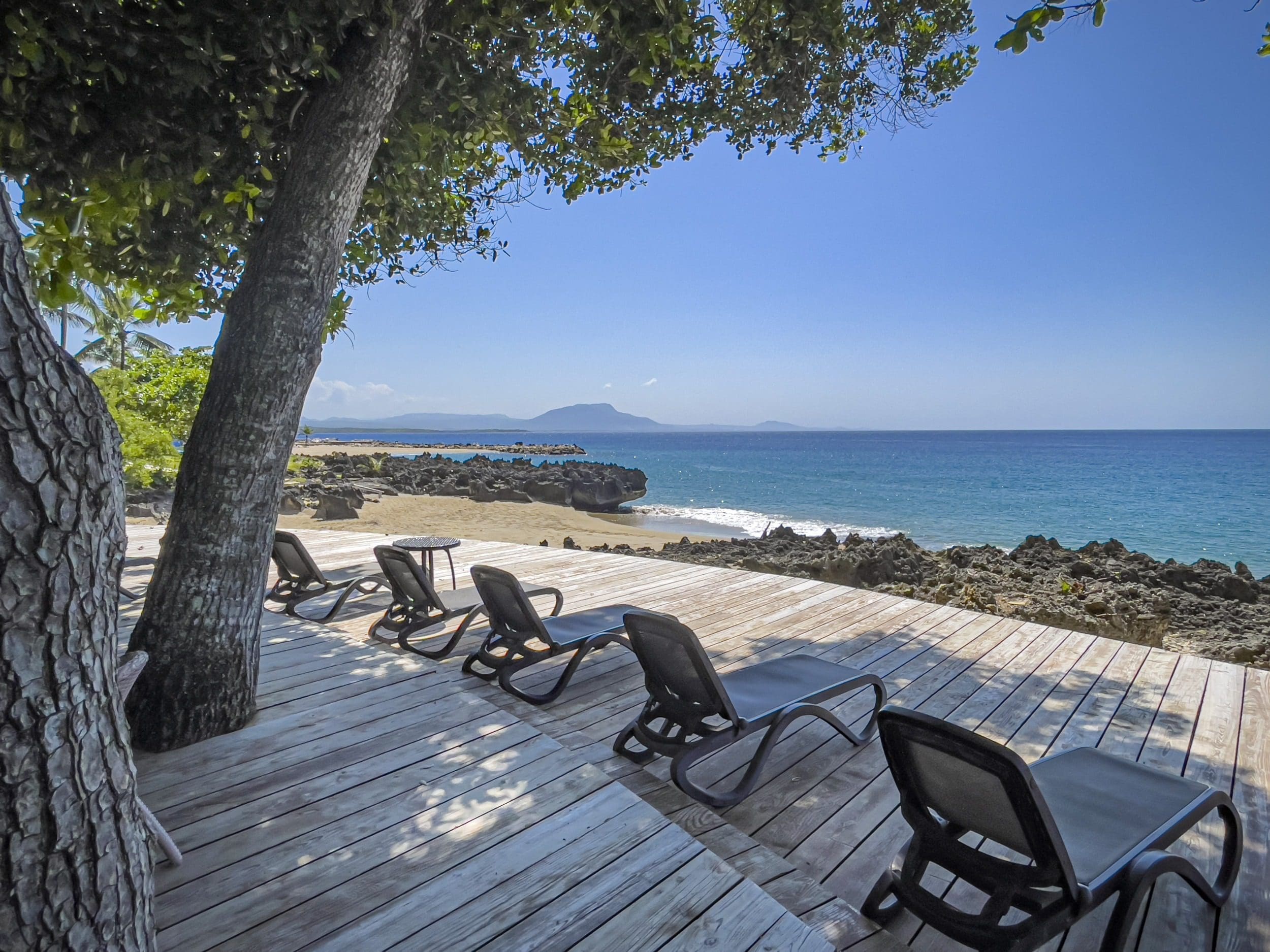 buyDRproperty Lounge chairs on a wooden deck overlooking Sosua beach in the Dominican Republic Sosua Real Estate
