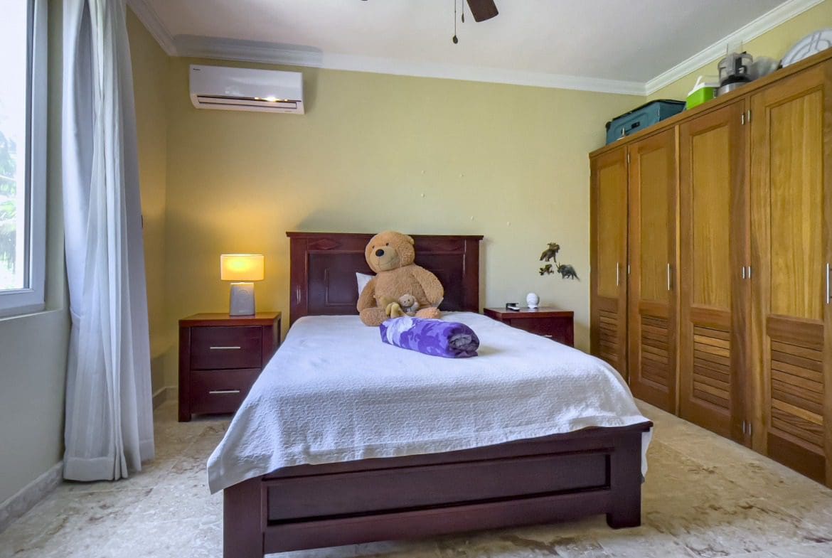 buyDRproperty Bedroom with a bed, nightstands, and wardrobe. Sosua Real Estate