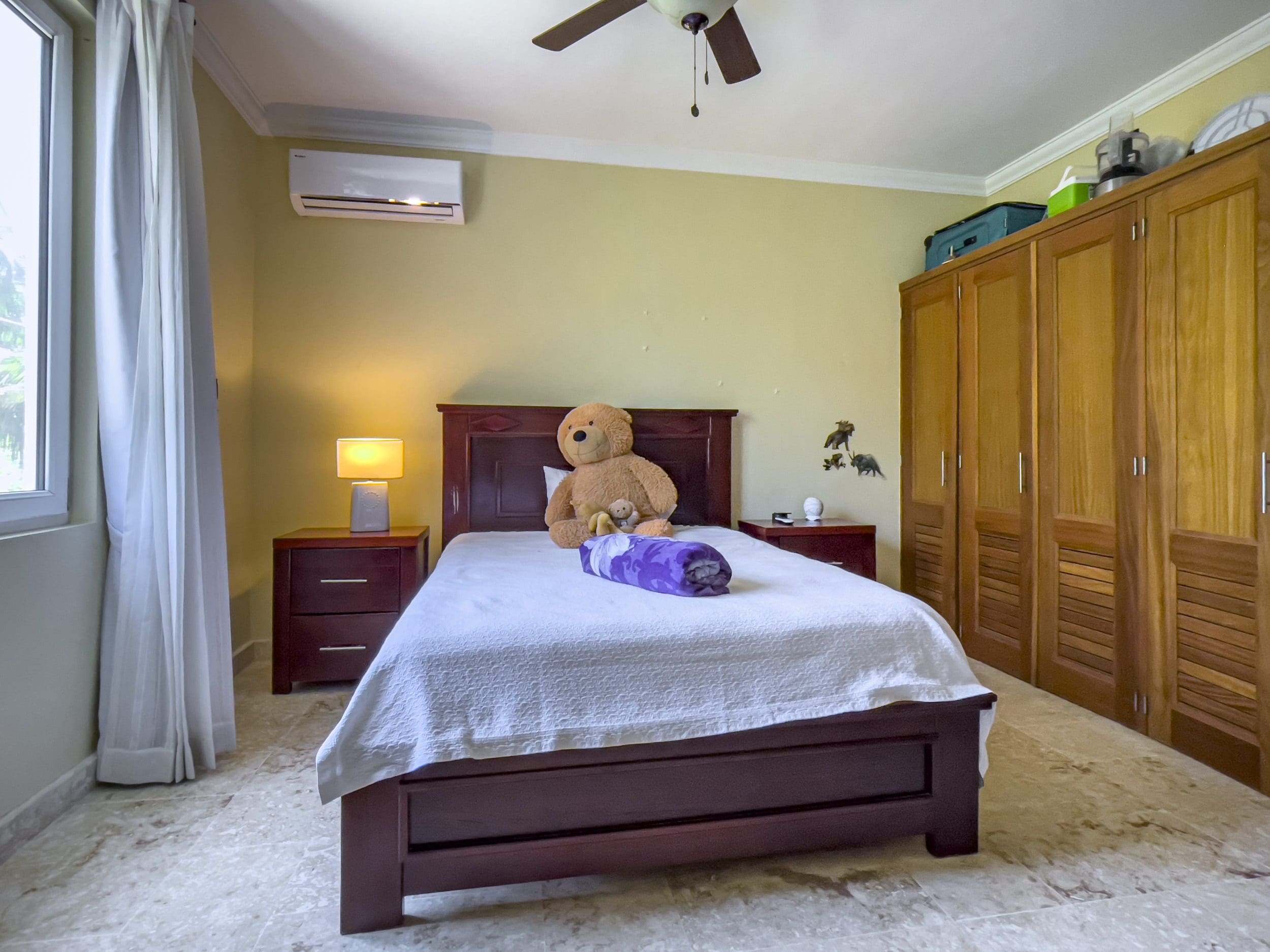 buyDRproperty Bedroom with a bed, nightstands, and wardrobe. Sosua Real Estate