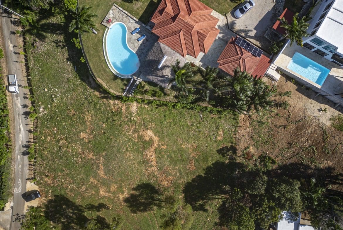 buyDRproperty Aerial view of a beautiful property with a pool and a large lot for sale. Sosua Real Estate