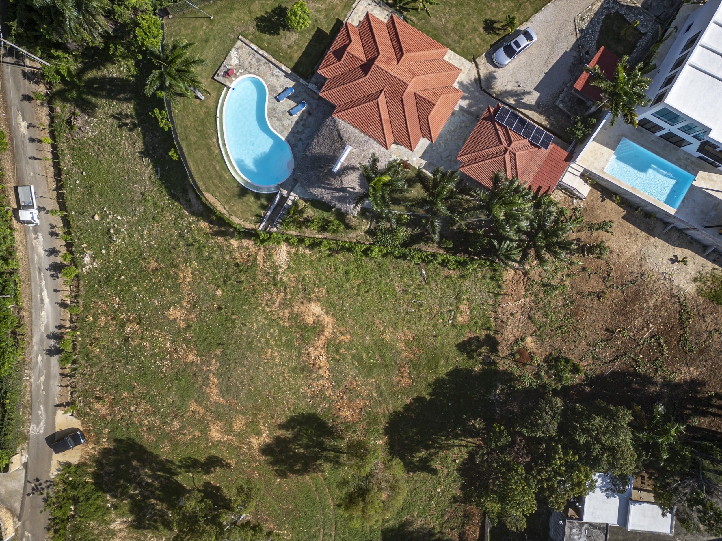 buyDRproperty Aerial view of a beautiful property with a pool and a large lot for sale. Sosua Real Estate