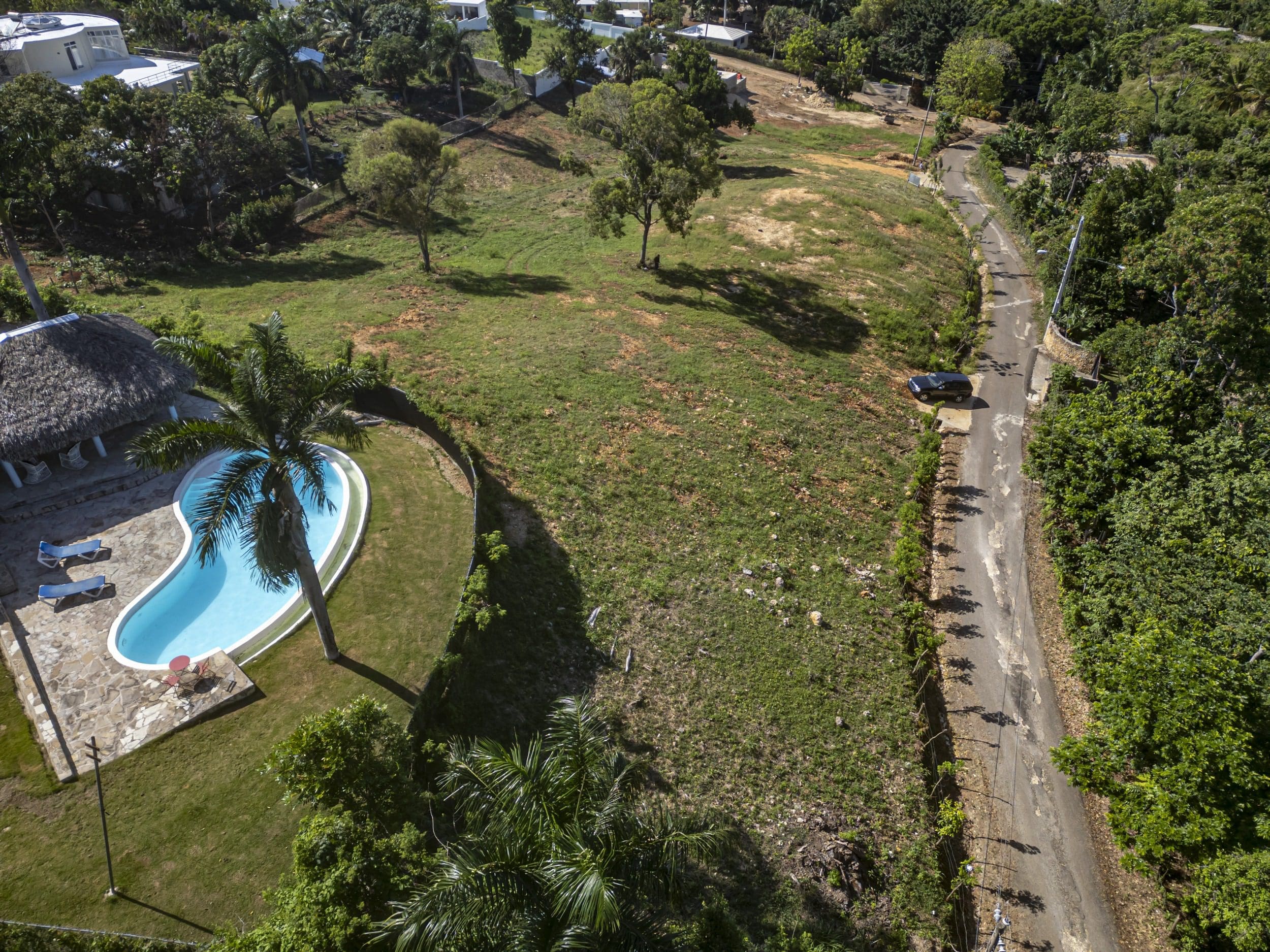 buyDRproperty Aerial view of a beautiful ocean view lot with pool and road in Sosua Sosua Real Estate