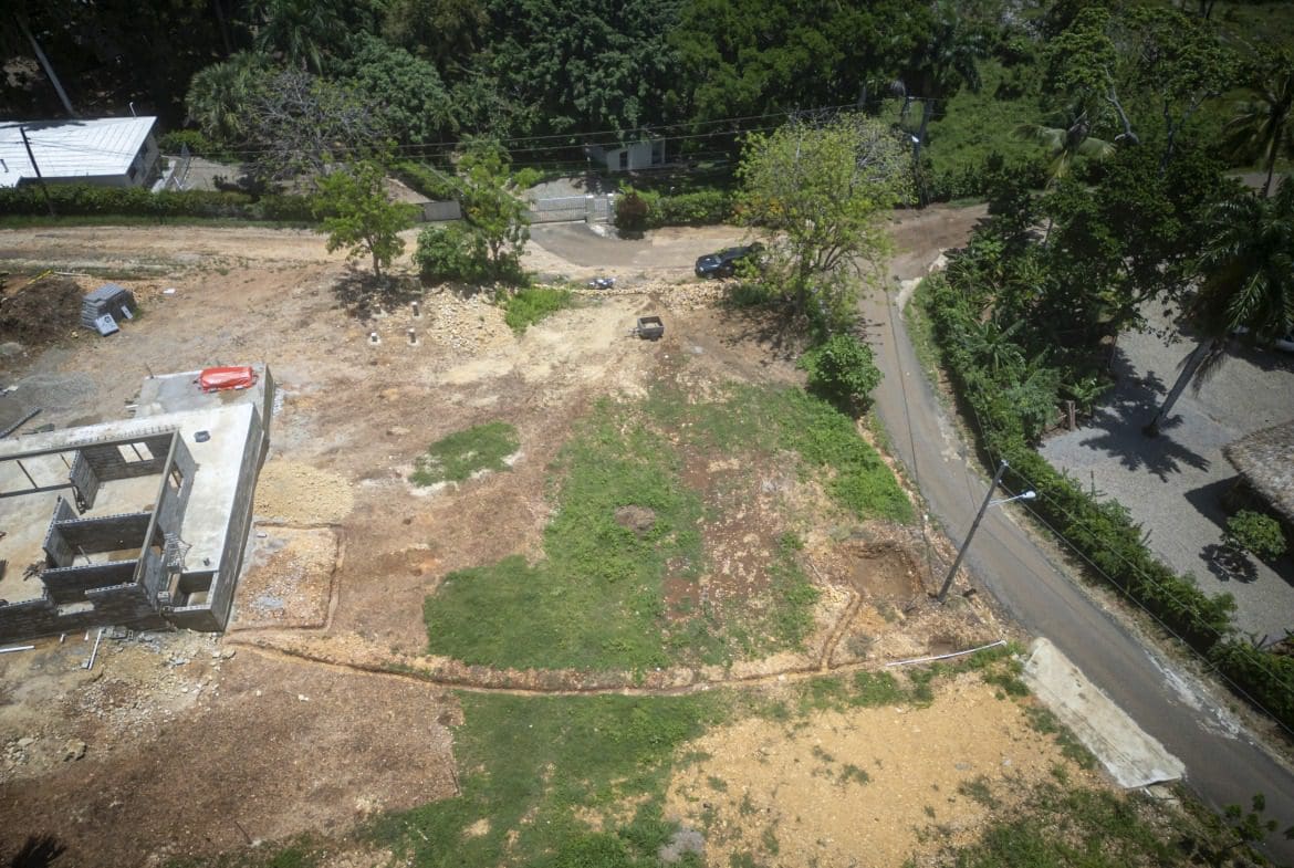 buyDRproperty Aerial view of a country side building lot in Sosua with a partially built structure. Sosua Real Estate