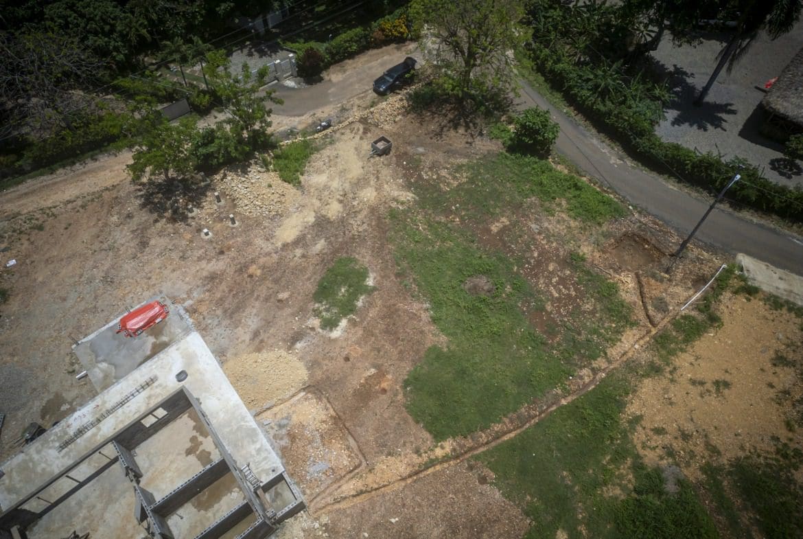 buyDRproperty Aerial view of a building lot in Sosua, with a concrete foundation and surrounding land. Sosua Real Estate