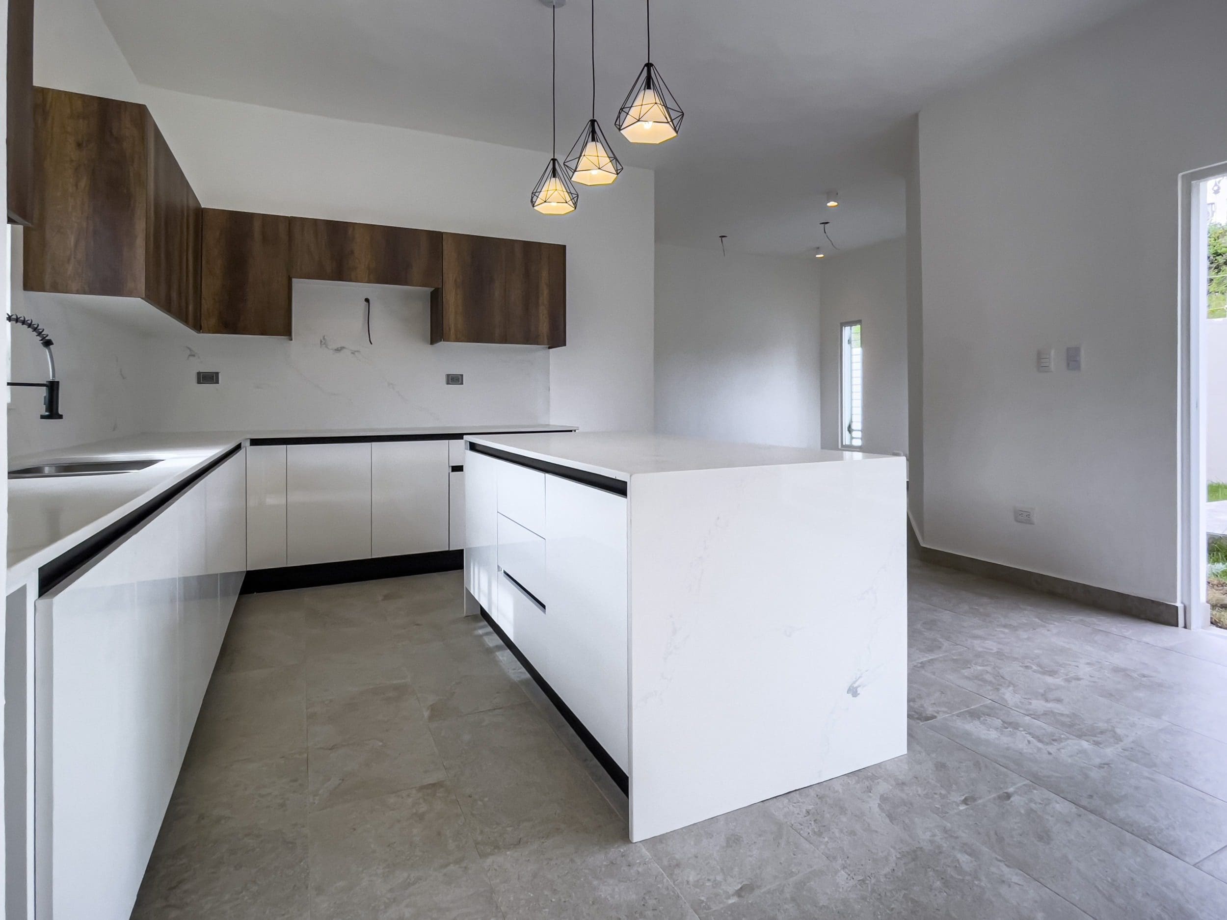 buyDRproperty Modern kitchen with white cabinets in a villa for sale Sosua Real Estate