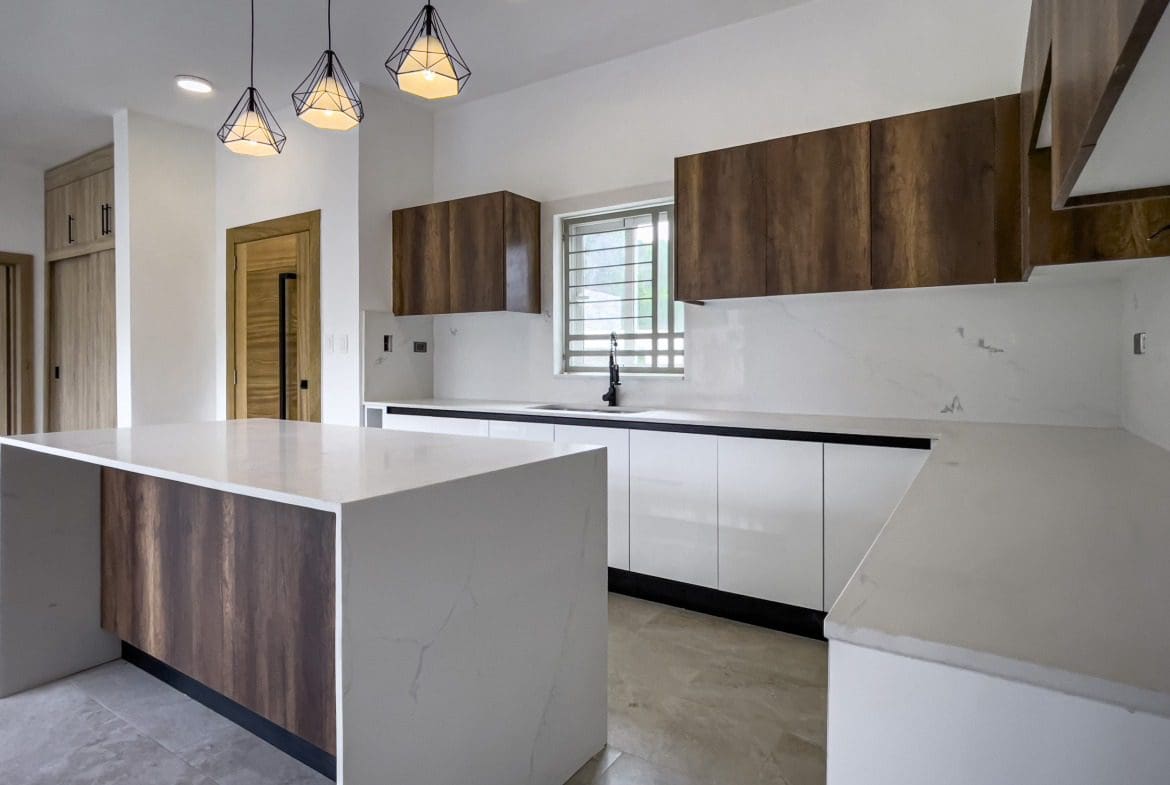 buyDRproperty Modern kitchen with wood cabinets in a villa for sale. Sosua Real Estate