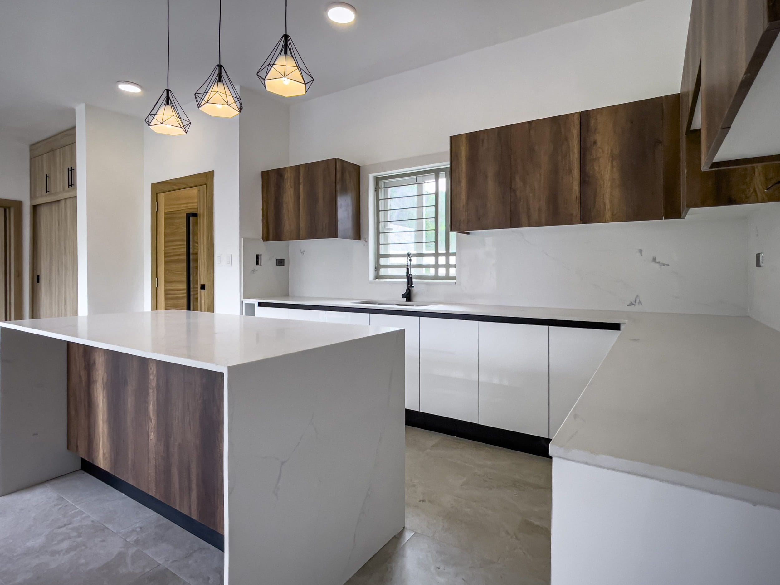 buyDRproperty Modern kitchen with wood cabinets in a villa for sale. Sosua Real Estate