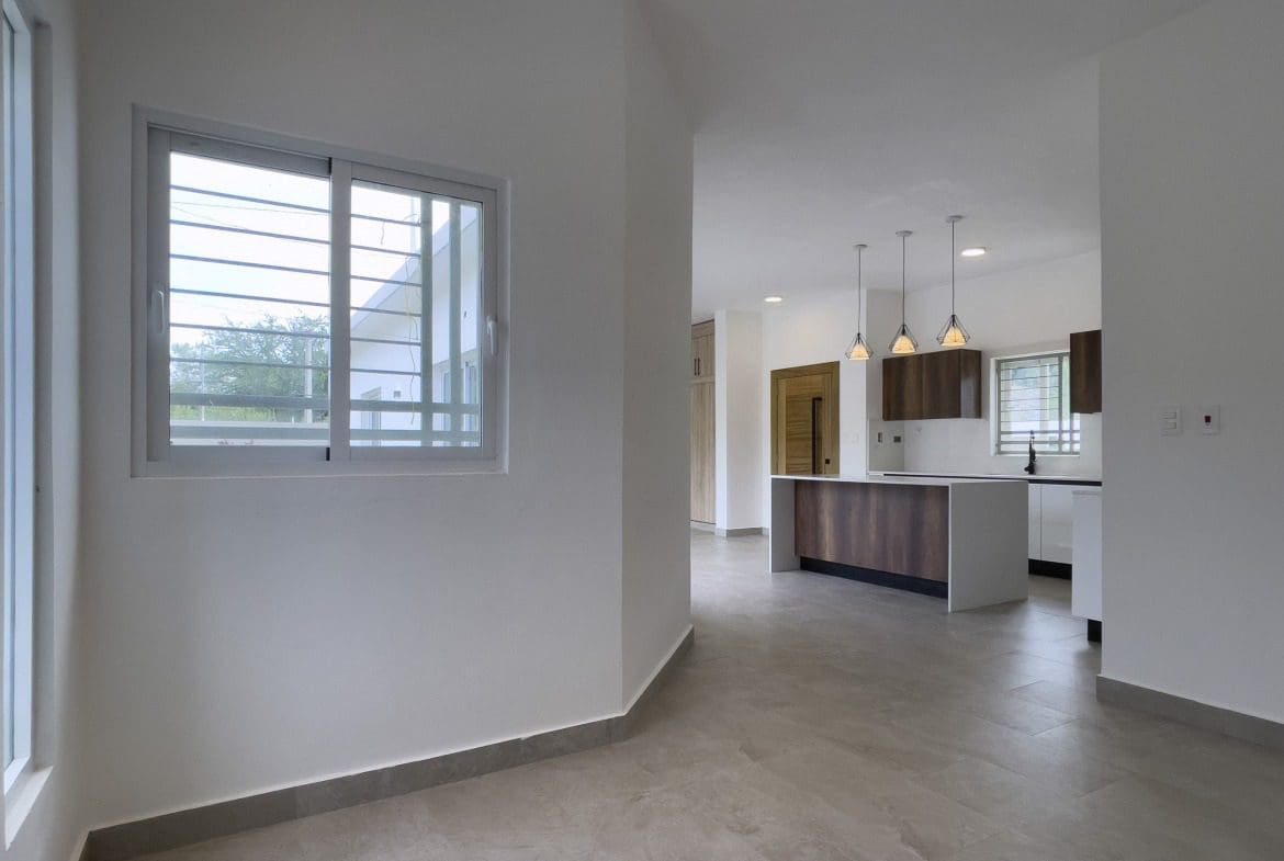 buyDRproperty Modern kitchen in a villa for sale with island and pendant lights. Sosua Real Estate