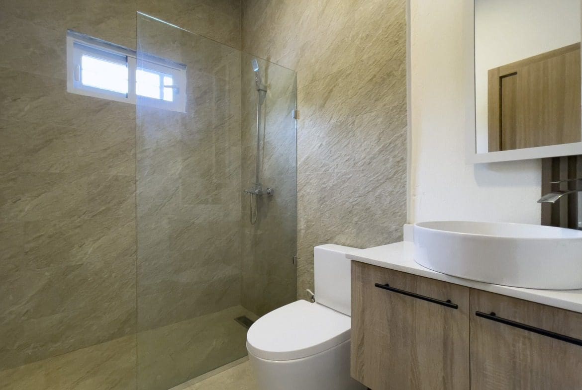 buyDRproperty Modern bathroom in a villa for sale featuring a walk-in shower and a stylish vanity. Sosua Real Estate
