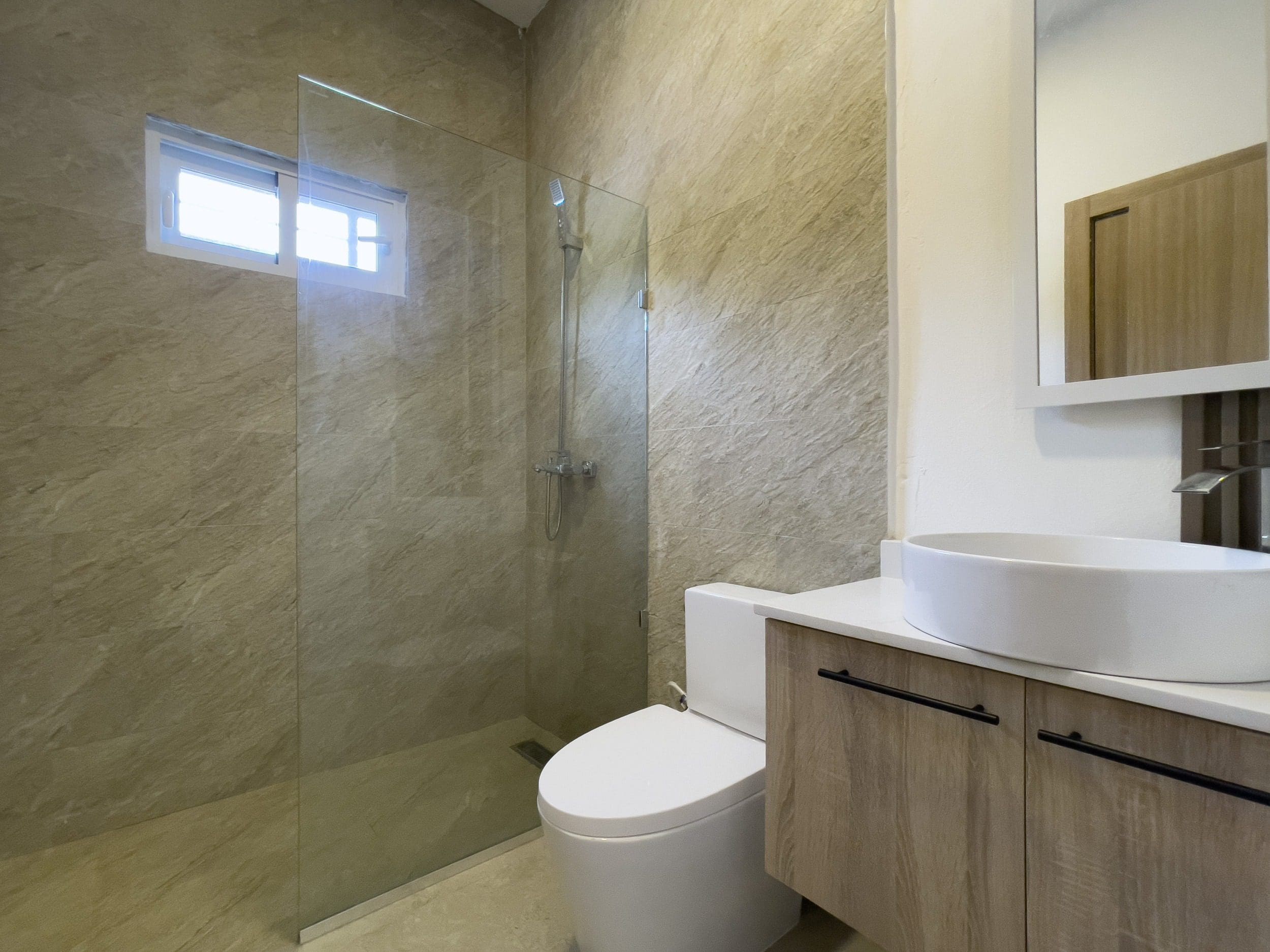 buyDRproperty Modern bathroom in a villa for sale featuring a walk-in shower and a stylish vanity. Sosua Real Estate