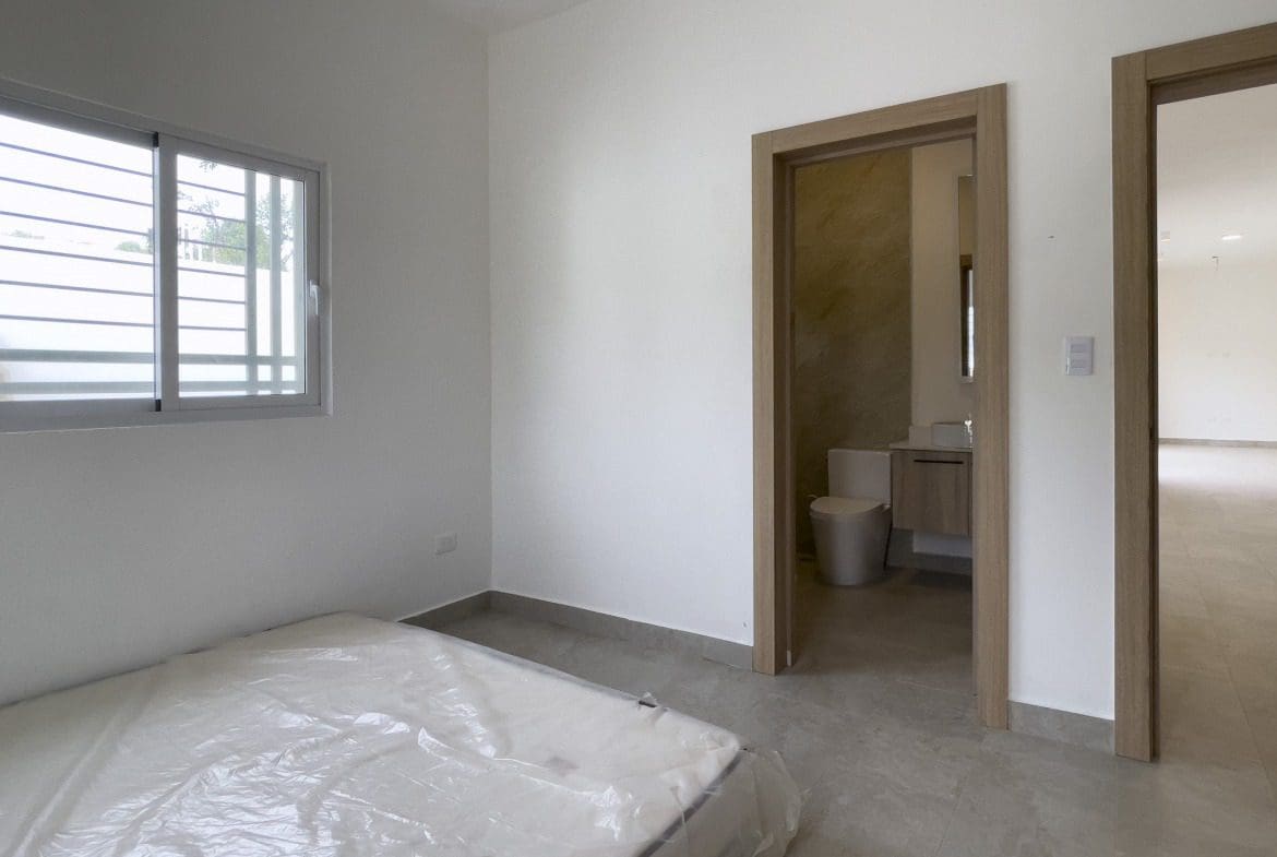 buyDRproperty Empty bedroom with a mattress in a modern villa for sale. Sosua Real Estate