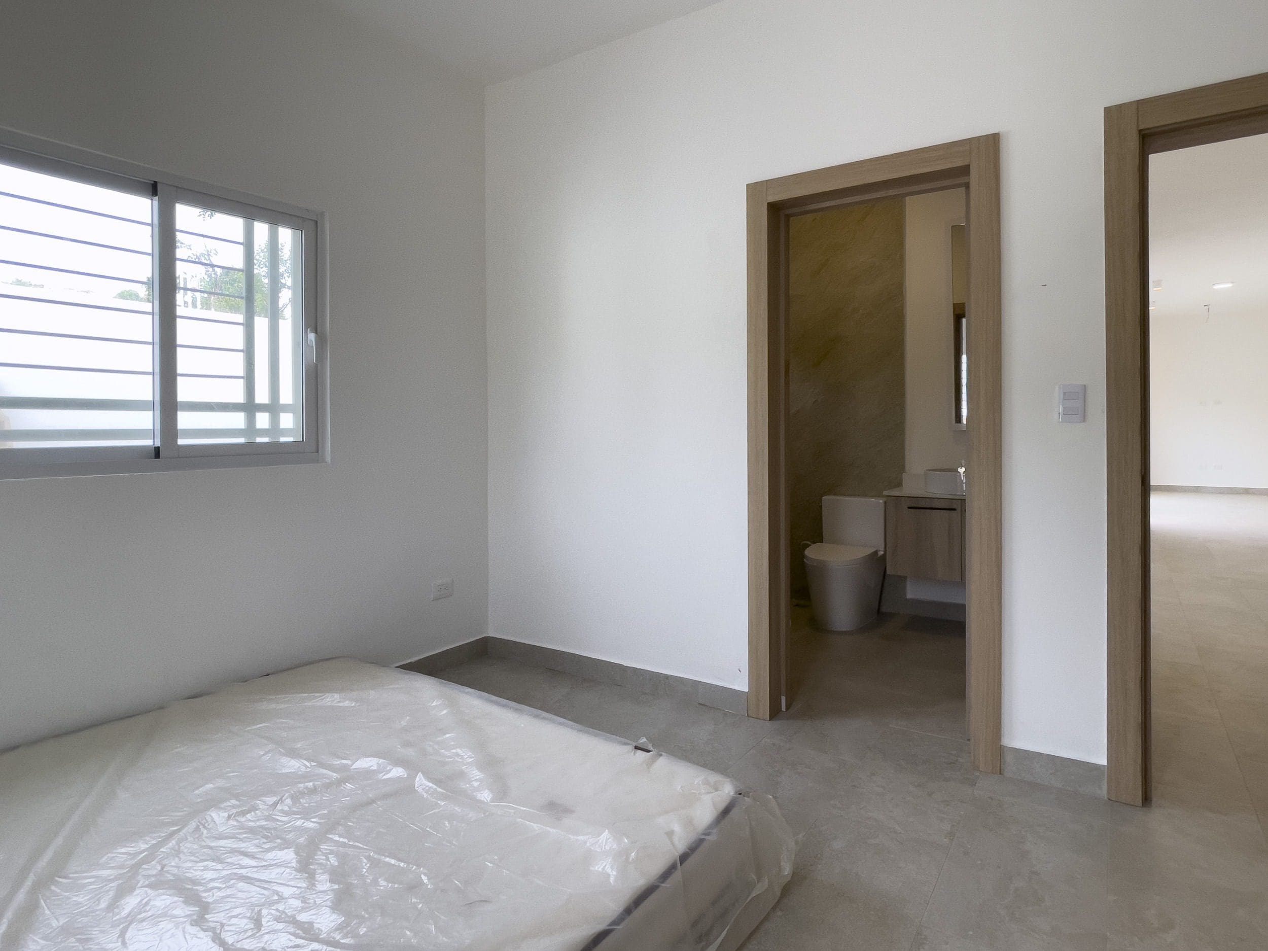 buyDRproperty Empty bedroom with a mattress in a modern villa for sale. Sosua Real Estate