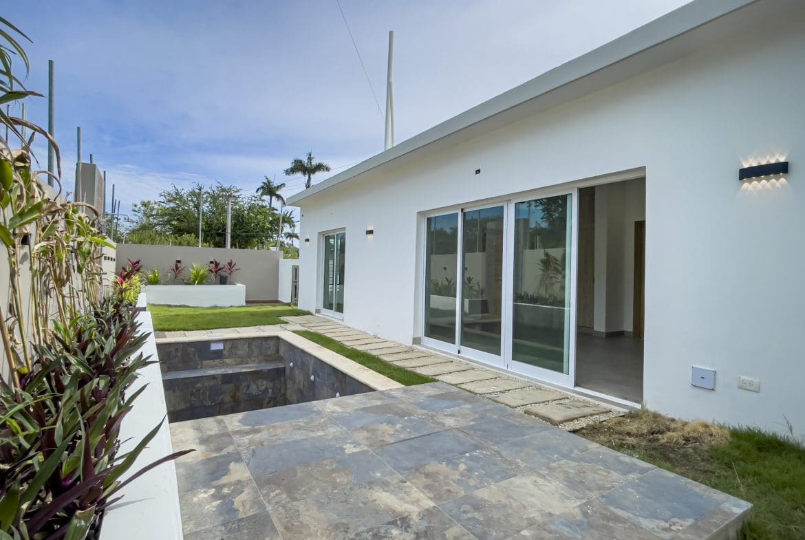 buyDRproperty Modern villa for sale with a pool area and lawn. Sosua Real Estate