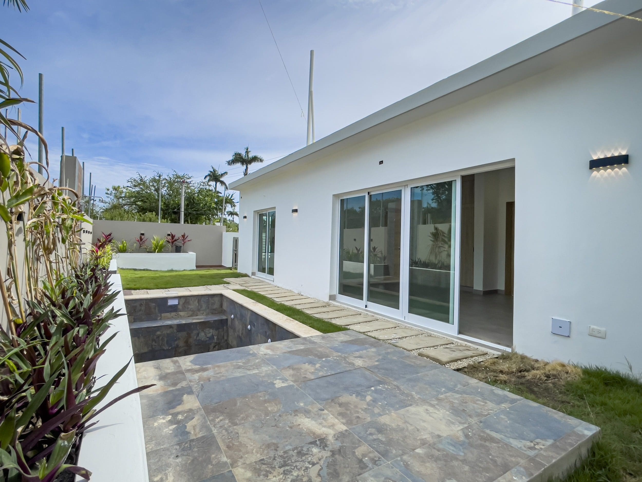 buyDRproperty Modern villa for sale with a pool area and lawn. Sosua Real Estate