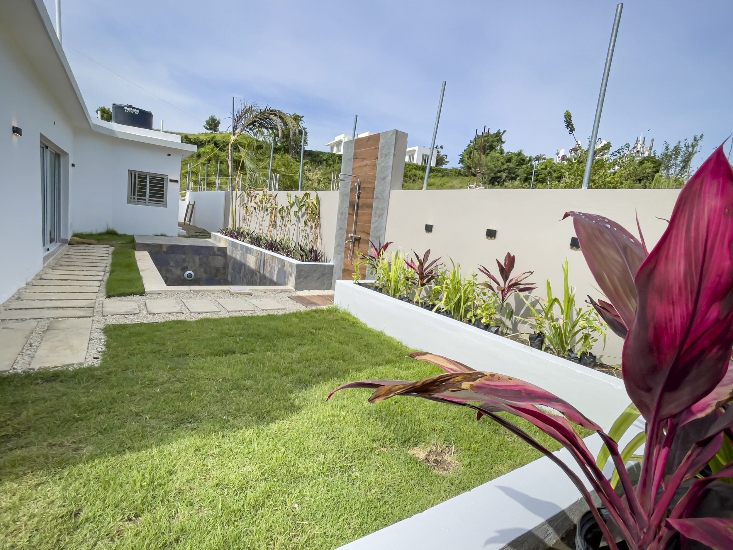 buyDRproperty Modern villa for sale in Sosua Hills with pool and lush landscaping. Sosua Real Estate