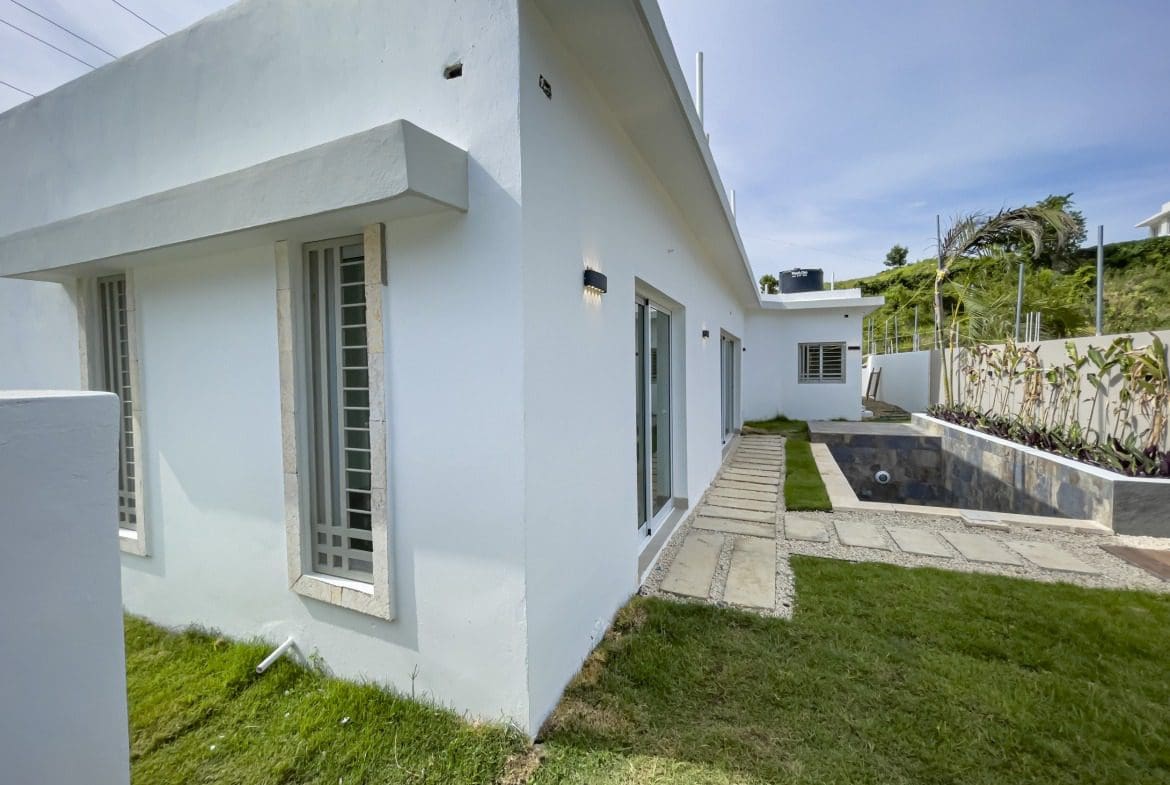 buyDRproperty Modern villa for sale in Sosua Hills with a pool and lawn. Sosua Real Estate